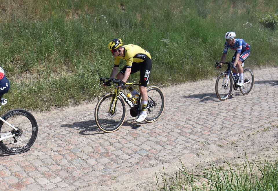 Riders on a cobbled farm track during the Four Days of Dunkirk