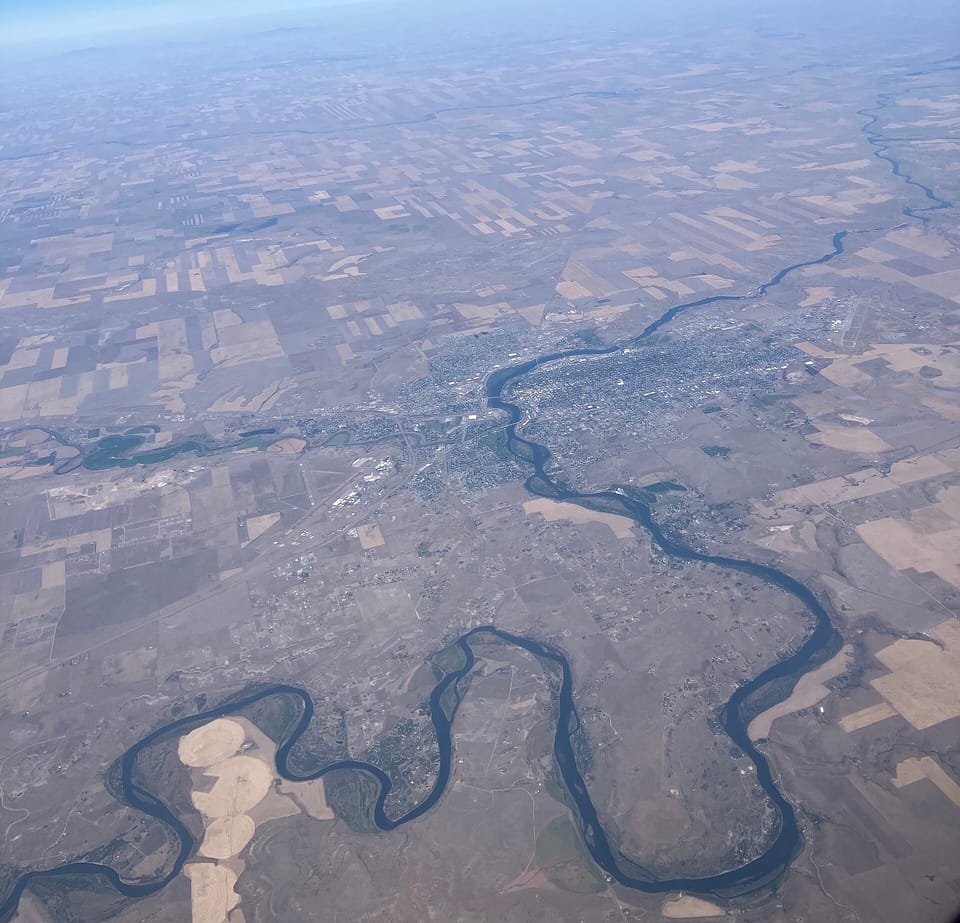 Aerial view of the Missouri River winding through the city of Great Falls and surrounding farmland