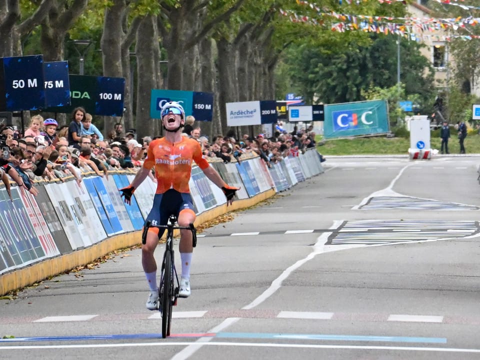 Demi Vollering celebrating as she crosses the finish line to win the 2025 European road race championship